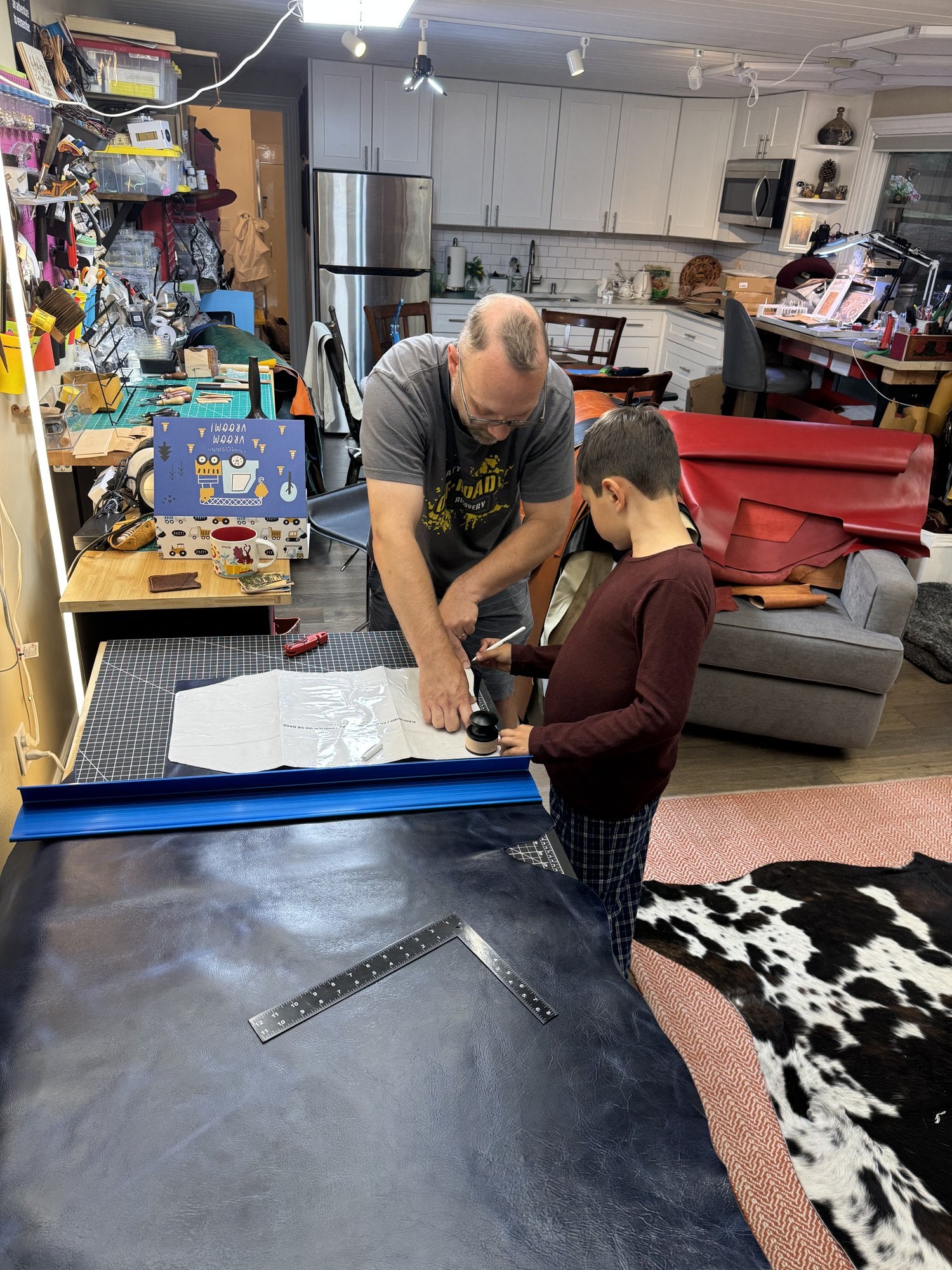 Our family working together at the cutting table in our Bellevue home shop