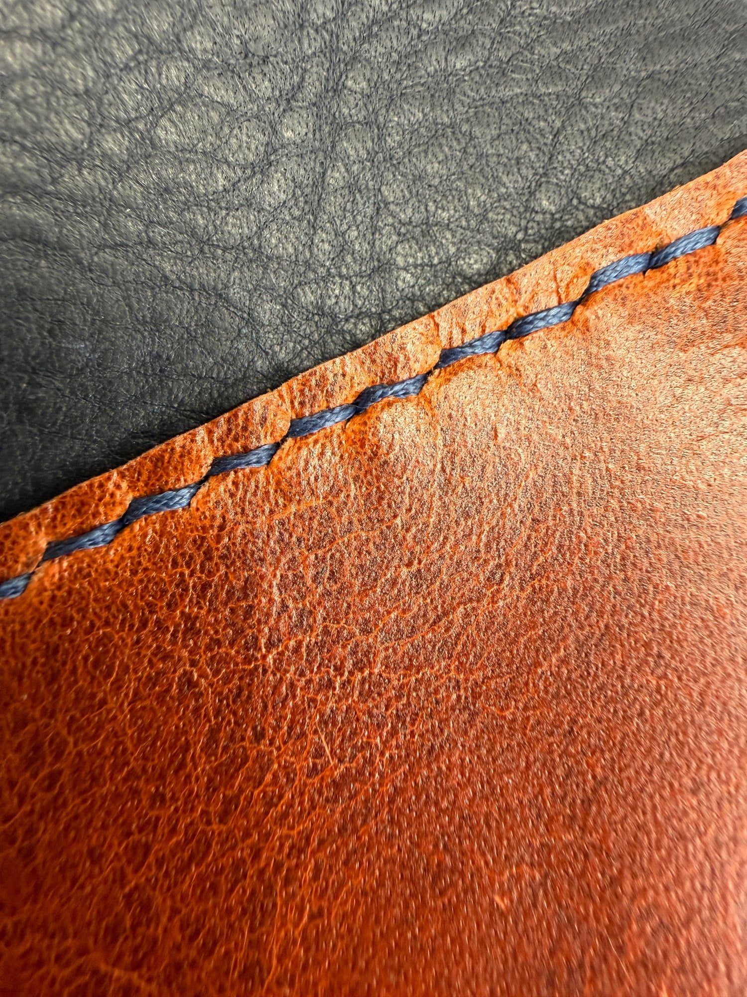 A closer look at the saddle stitching along a hand-cut mountain edge.