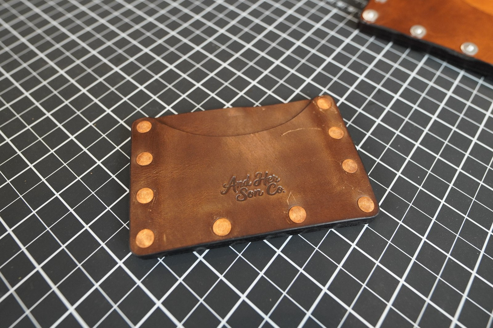 Tyr compact leather card wallet with exposed rivets